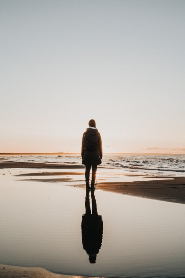 Woman staring out at the ocean